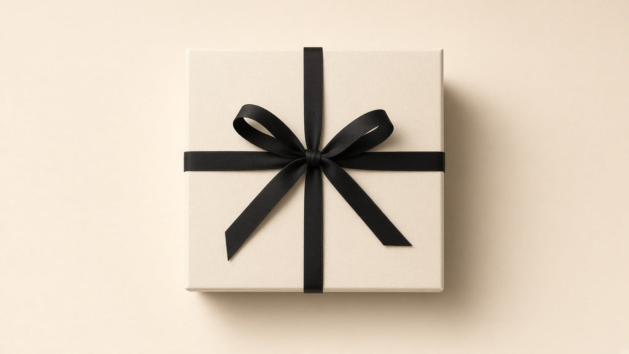 Cream gift box tied with a black ribbon